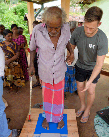 Massaging rigid feet wearing toe socks.